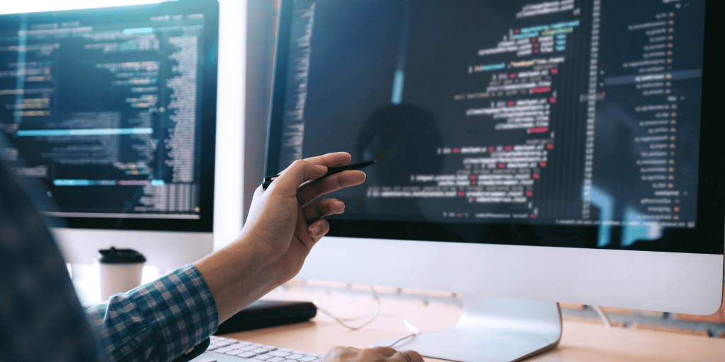 Developer pointing to code on screen